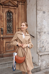 a lady in a white shirt and a long trench coat